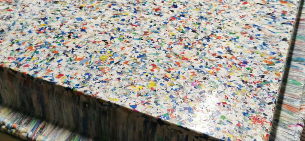 Recycled plastic that can be used for tabletops and other hard surfaces.