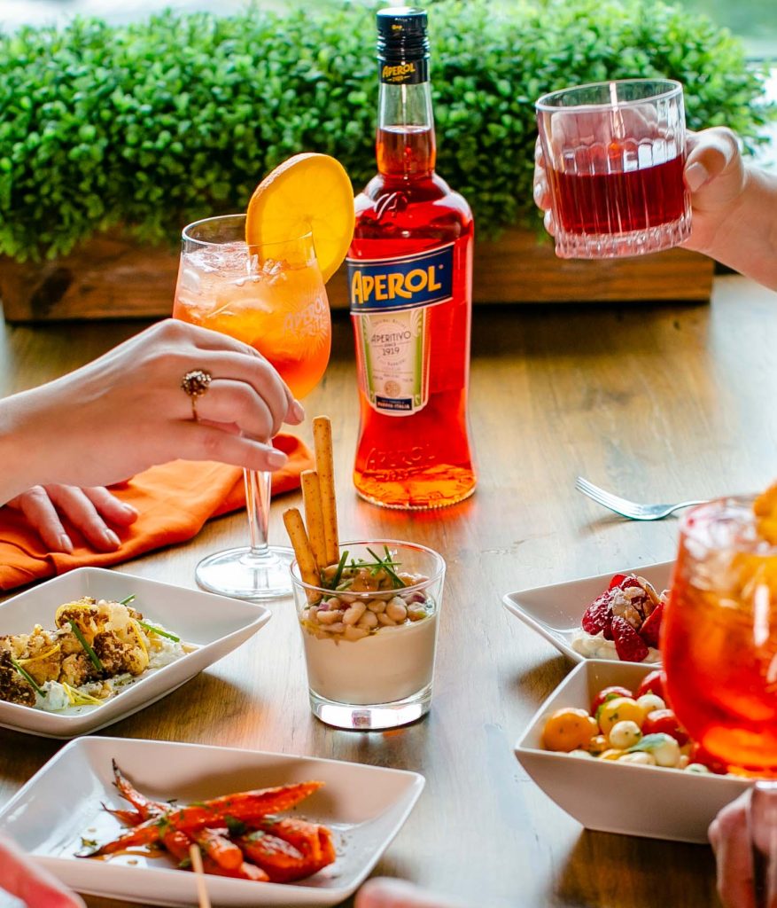 group dining at table with drinks and food